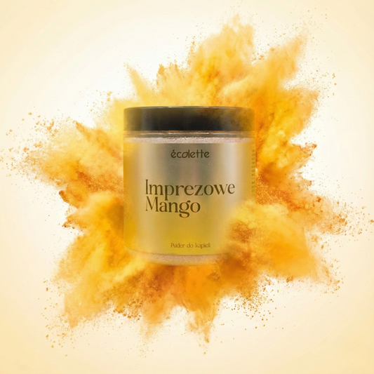 Puder do kąpieli Imprezowe Mango Écolette na tle dynamicznego wybuchu żółto-pomarańczowego pudru podkreślającego tropikalny charakter.
